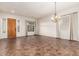 Open-concept living room showcasing tile floors, natural light, and a decorative chandelier at 12702 W Dove Wing Way, Peoria, AZ 85383