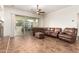 Spacious living room with tile flooring, neutral colors, and sliding doors to backyard at 12702 W Dove Wing Way, Peoria, AZ 85383