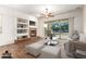 Cozy living room with a fireplace, built-in shelving, and sliding doors to the outdoor space at 12702 W Dove Wing Way, Peoria, AZ 85383
