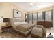 Comfortable main bedroom with a ceiling fan, ample natural light, and a decorative rug at 12702 W Dove Wing Way, Peoria, AZ 85383