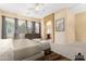 Spacious main bedroom features neutral decor, large windows, and an ensuite bathroom at 12702 W Dove Wing Way, Peoria, AZ 85383