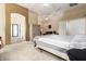 Spacious main bedroom featuring neutral colors, a ceiling fan, and a sitting area for relaxation at 12702 W Dove Wing Way, Peoria, AZ 85383