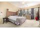 Spacious main bedroom with a large headboard, neutral decor, and an en-suite bathroom at 12702 W Dove Wing Way, Peoria, AZ 85383
