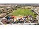 Aerial view showcasing a park with green space, playground areas, and walking paths in a residential community at 12702 W Dove Wing Way, Peoria, AZ 85383