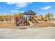 A well-equipped playground with slides, climbing frames, and a shaded seating area, perfect for Gathering enjoyment at 12702 W Dove Wing Way, Peoria, AZ 85383