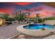 Stunning pool with natural stone accents, built in spa, and lush landscaping at 12702 W Dove Wing Way, Peoria, AZ 85383