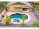 Inviting backyard oasis with a sparkling pool, spa, covered patio, and lush landscaping at 12702 W Dove Wing Way, Peoria, AZ 85383
