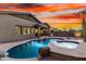 Inviting backyard with a beautiful pool and spa, enhanced by serene desert landscaping at 12702 W Dove Wing Way, Peoria, AZ 85383