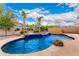 Private backyard pool and spa area with stone accents, lush landscaping, and secure fencing at 12702 W Dove Wing Way, Peoria, AZ 85383