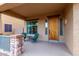 Cozy front porch with stone accents, seating, and a decorative front door at 12702 W Dove Wing Way, Peoria, AZ 85383