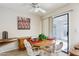 Cozy dining area with a round table, comfortable seating, and natural light from sliding doors at 12726 W Copperstone Dr, Sun City West, AZ 85375
