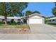 Charming single-story home with a well-maintained lawn, mature trees, and a two-car garage at 12726 W Copperstone Dr, Sun City West, AZ 85375