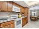 Efficient kitchen featuring wooden cabinets, modern white appliances, and ample counter space at 12726 W Copperstone Dr, Sun City West, AZ 85375