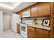 Efficient kitchen featuring wooden cabinets, modern white appliances, and ample counter space at 12726 W Copperstone Dr, Sun City West, AZ 85375