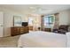 Sunlit main bedroom with a spacious layout, dresser, and en-suite bathroom access at 12726 W Copperstone Dr, Sun City West, AZ 85375