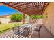 Inviting back patio featuring a pergola that provides shade, perfect for outdoor dining and relaxation at 1432 W Hopi Dr, Chandler, AZ 85224