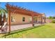 Expansive backyard with a pergola-covered patio, lush lawn, and mature trees, perfect for outdoor living at 1432 W Hopi Dr, Chandler, AZ 85224