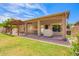 Backyard with covered patio, lush green lawn, and a cozy pergola area, ideal for entertaining at 1432 W Hopi Dr, Chandler, AZ 85224