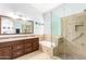 Bright bathroom features double sinks, soaking tub, and walk-in glass shower at 1432 W Hopi Dr, Chandler, AZ 85224