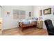 Bedroom with laminate wood flooring, artwork and a single window at 1432 W Hopi Dr, Chandler, AZ 85224