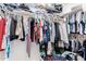 Walk-in closet with clothes hanging from the clothing rod and storage shelves at 1432 W Hopi Dr, Chandler, AZ 85224