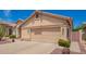 Single-story home with a two-car garage, concrete driveway, and desert landscaping at 1432 W Hopi Dr, Chandler, AZ 85224