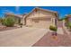 Single-story home with a two-car garage, concrete driveway, and desert landscaping at 1432 W Hopi Dr, Chandler, AZ 85224