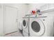 Laundry room with washer, dryer, upper cabinets, and access to the backyard at 1432 W Hopi Dr, Chandler, AZ 85224