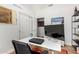 Office space with a sleek white desk and a large built-in bookshelf for storage at 1432 W Hopi Dr, Chandler, AZ 85224