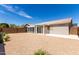 Spacious backyard featuring desert landscaping and a sunroom for outdoor enjoyment at 15047 W Kings Dr, Surprise, AZ 85374