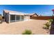 Lush backyard featuring a sunroom and desert landscaping, perfect for outdoor activities and relaxation at 15047 W Kings Dr, Surprise, AZ 85374