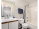 Bathroom features a single sink vanity, toilet, and shower-tub combination with tiled walls at 15047 W Kings Dr, Surprise, AZ 85374