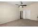 Large bedroom with neutral carpet, a ceiling fan, and closet at 15047 W Kings Dr, Surprise, AZ 85374