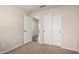 Bedroom with neutral walls, carpet, closet, and paneled doors to additional rooms at 15047 W Kings Dr, Surprise, AZ 85374