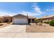 Charming single-story home with desert landscaping, a two-car garage, and an American flag at 15047 W Kings Dr, Surprise, AZ 85374