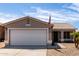 A close-up of an exterior elevation with a two-car garage and an American flag at 15047 W Kings Dr, Surprise, AZ 85374