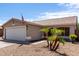 A close-up of an exterior elevation with a two-car garage and desert landscaping at 15047 W Kings Dr, Surprise, AZ 85374