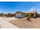 Charming single-story home with a two-car garage and manicured desert landscaping at 15047 W Kings Dr, Surprise, AZ 85374