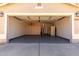 Spacious garage with epoxy floors, built-in cabinets, and overhead lighting for easy parking at 15047 W Kings Dr, Surprise, AZ 85374
