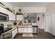 Bright kitchen with stainless steel appliances, white cabinets, marble countertops, and an open layout at 15047 W Kings Dr, Surprise, AZ 85374