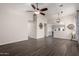 Spacious living room featuring modern flooring, a ceiling fan, and an open floor plan at 15047 W Kings Dr, Surprise, AZ 85374