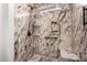 Shower with granite walls, bench, and shower head at 15047 W Kings Dr, Surprise, AZ 85374