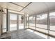 Bright sunroom with tiled floors and multiple windows offering a view of the outdoor patio at 15047 W Kings Dr, Surprise, AZ 85374