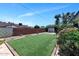 Artificial turf contrasts with rock landscaping in a private backyard, enclosed by a brick perimeter wall at 15049 N 25Th Pl, Phoenix, AZ 85032
