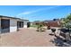 A beautiful backyard features a brick patio with a small palm tree and a grill at 15049 N 25Th Pl, Phoenix, AZ 85032