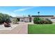 A well-maintained backyard is equipped with a brick path, palm trees, and lush greenery at 15049 N 25Th Pl, Phoenix, AZ 85032