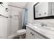 Bathroom features a shower with tiled walls, modern sink with vanity, and sleek mirror at 15049 N 25Th Pl, Phoenix, AZ 85032