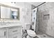 Bright bathroom features a marble-topped vanity, framed mirror, and tiled shower with floral curtain at 15049 N 25Th Pl, Phoenix, AZ 85032
