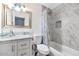 A renovated bathroom featuring modern fixtures, a marble-topped vanity, and tiled shower at 15049 N 25Th Pl, Phoenix, AZ 85032