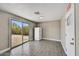 Flex room featuring wood flooring, a sliding glass door and an exit door at 15049 N 25Th Pl, Phoenix, AZ 85032
